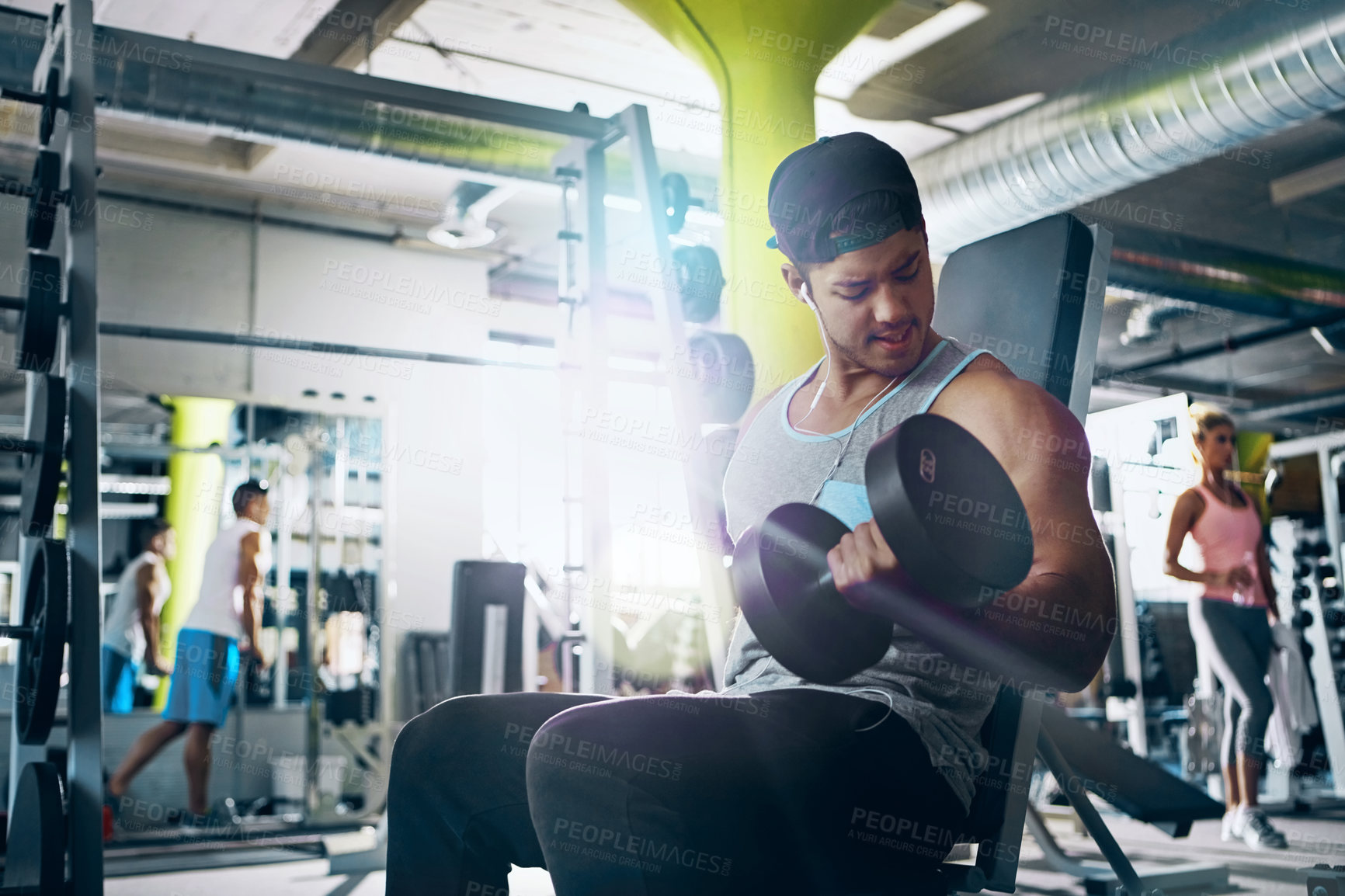 Buy stock photo Shot of a man doing a upper-body workout at the gym