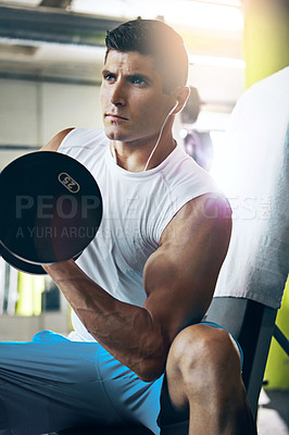 Buy stock photo Shot of a man doing a upper-body workout at the gym