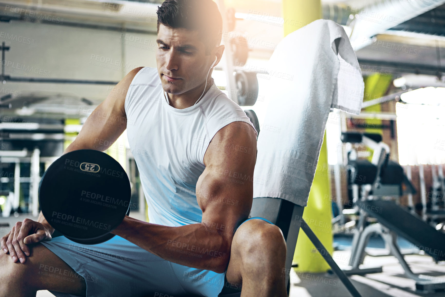 Buy stock photo Shot of a man doing a upper-body workout at the gym