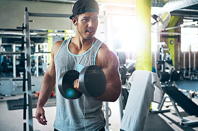 Buy stock photo Shot of a man doing weight training at the gym