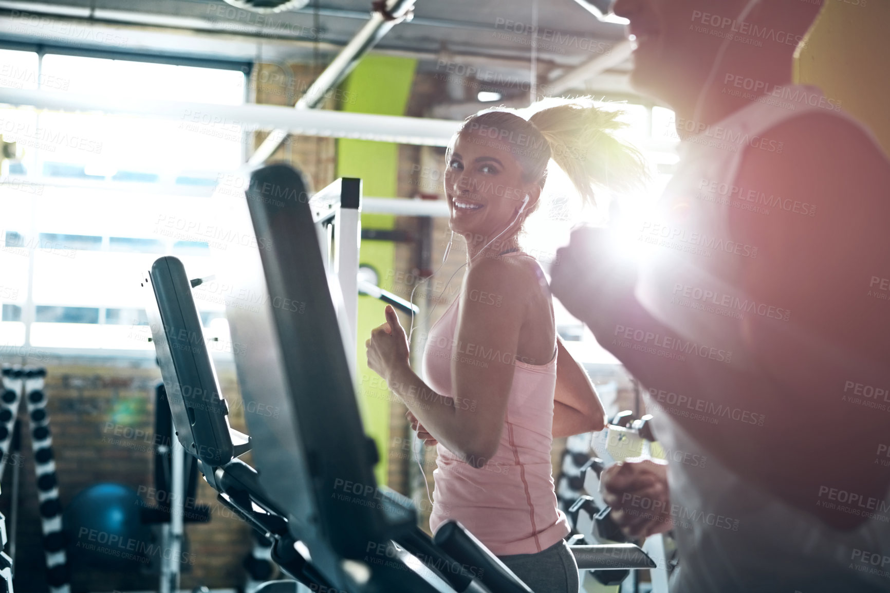 Buy stock photo Shot of a man and a woman working out together in the gym