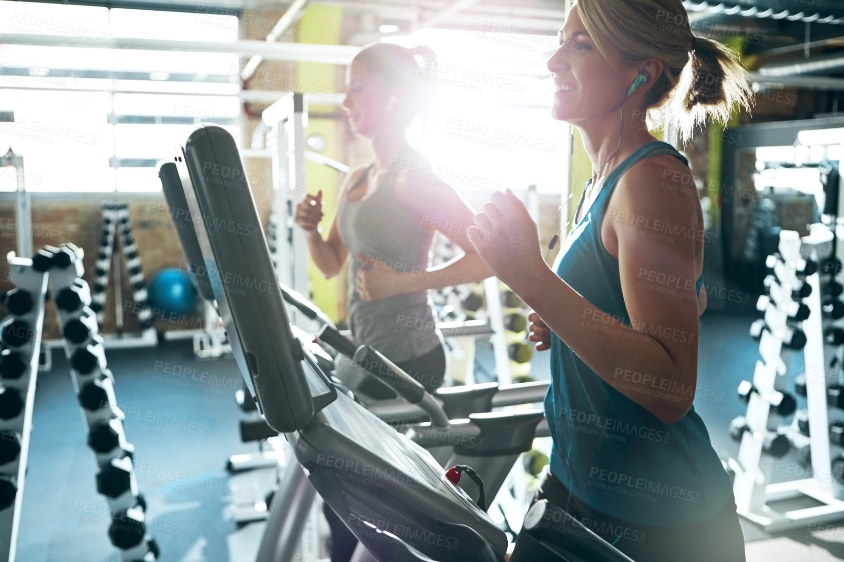 Buy stock photo Gym, earphones and women on treadmill, workout and training routine with music, running and wellness. Cardio, flare and people with tech for audio, exercise and fitness on equipment in health club