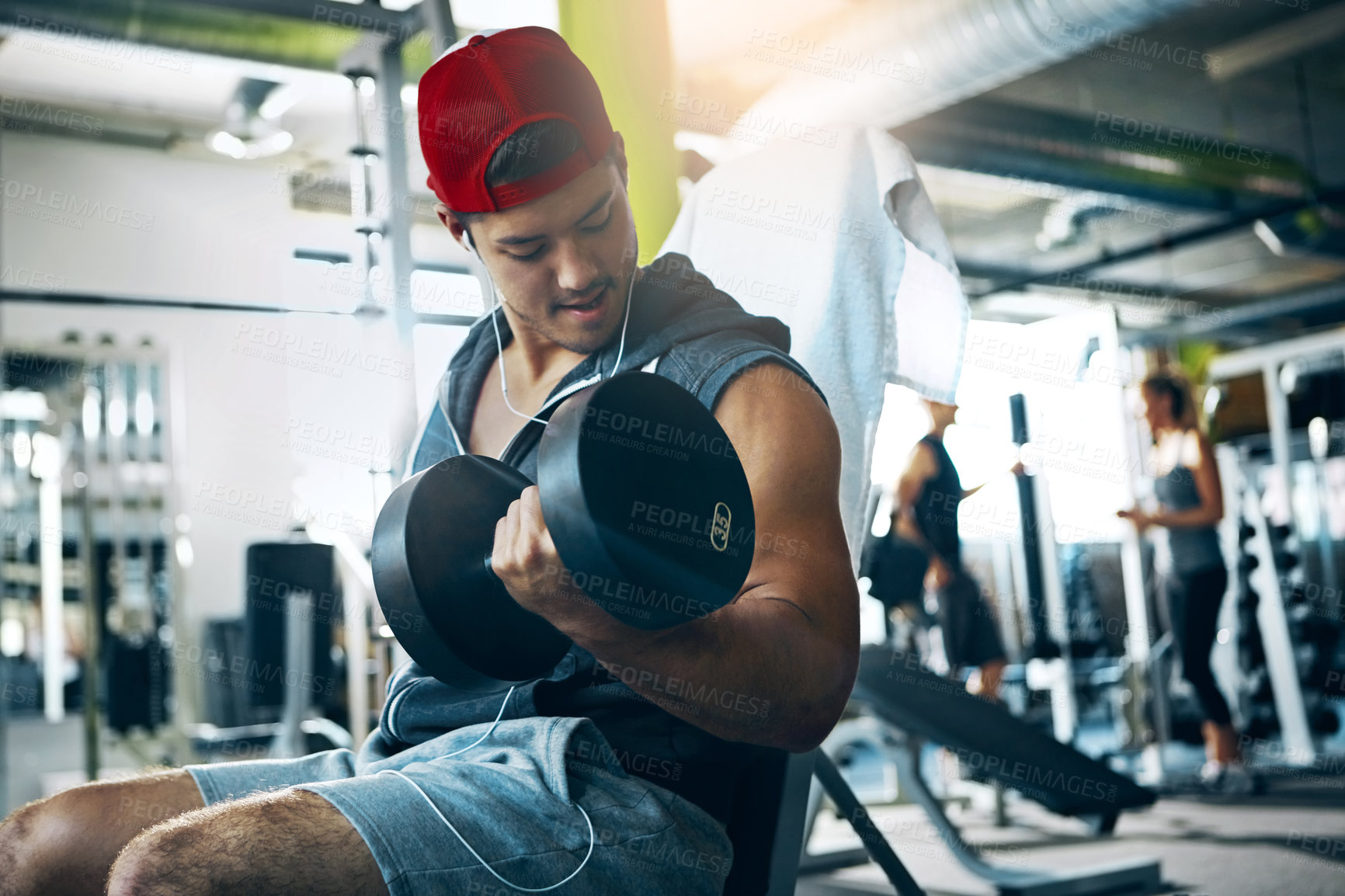 Buy stock photo Shot of a man doing a upper-body workout at the gym