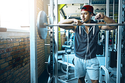 Buy stock photo Shot of a man doing weight training at the gym