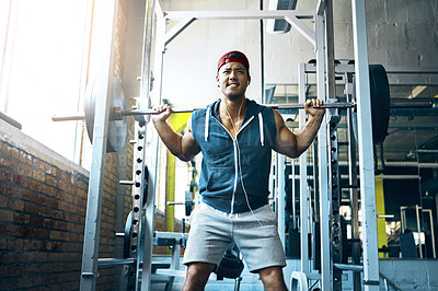 Buy stock photo Shot of a man doing weight training at the gym