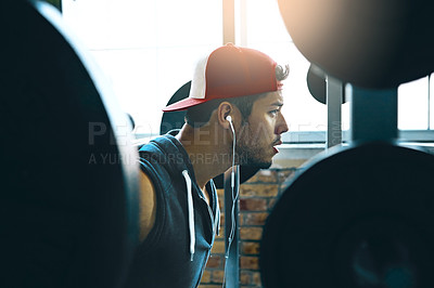 Buy stock photo Shot of a man doing weight training at the gym