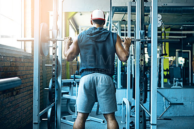 Buy stock photo Shot of a man doing weight training at the gym