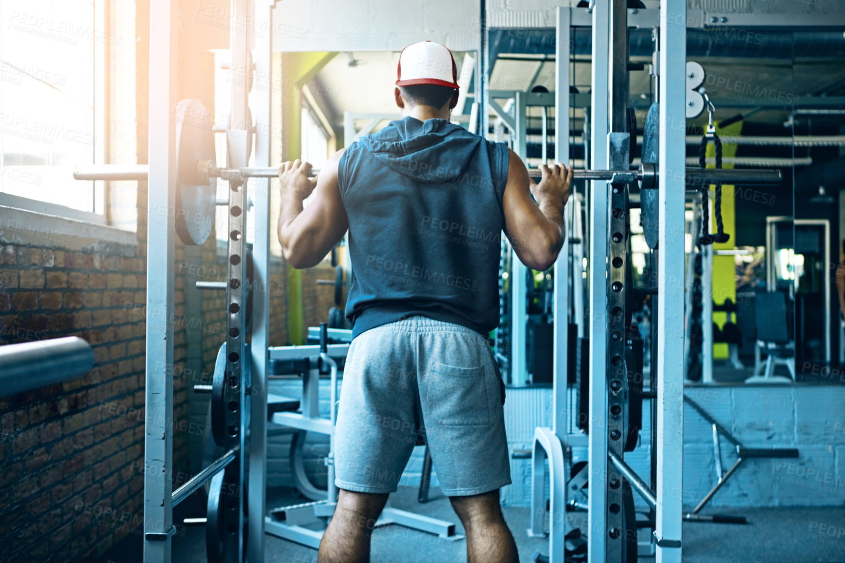 Buy stock photo Shot of a man doing weight training at the gym