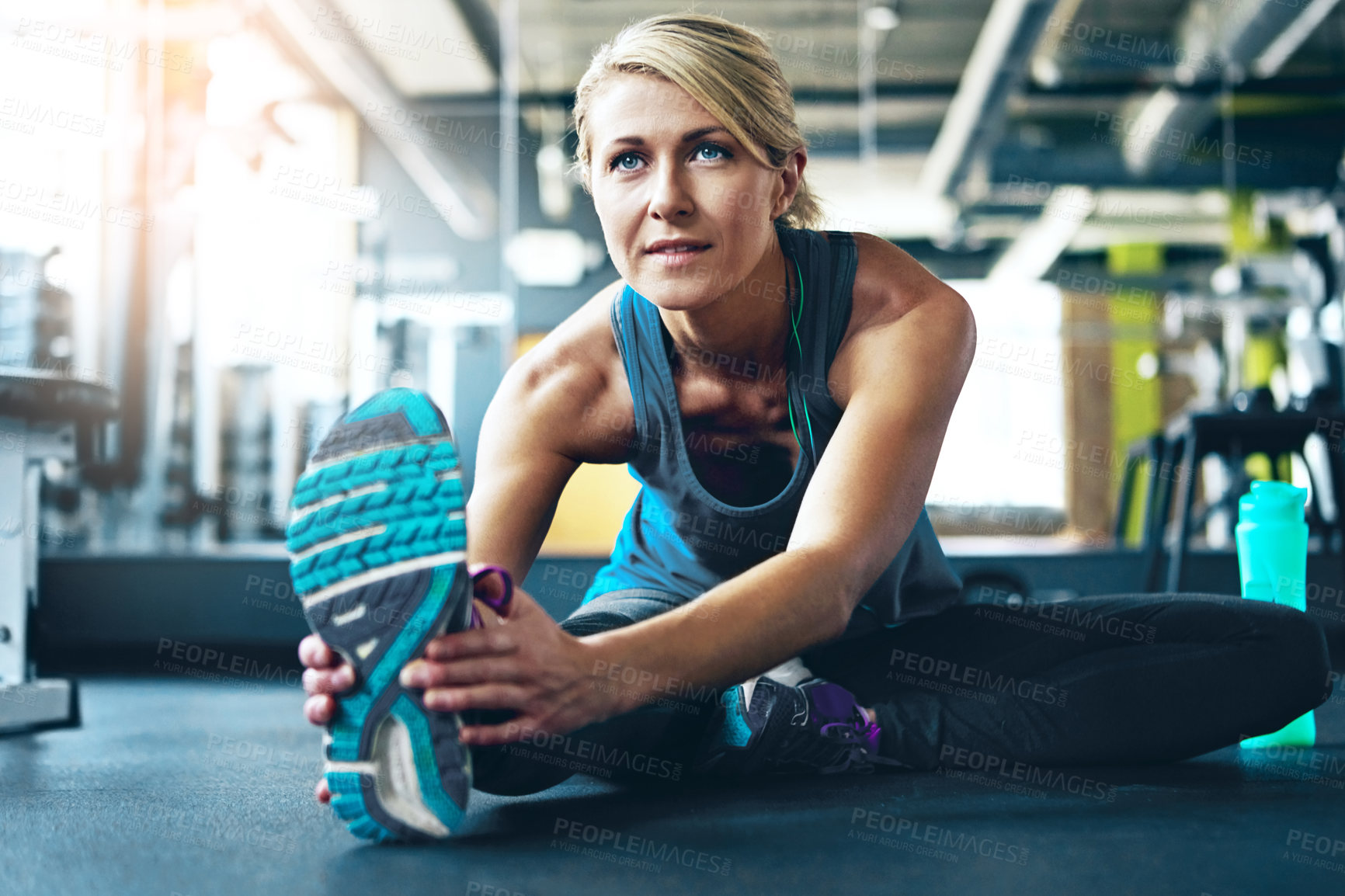 Buy stock photo Shot of a sporty woman working out at the gym