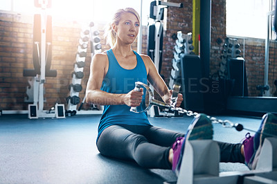 Buy stock photo Shot of a sporty woman working out at the gym