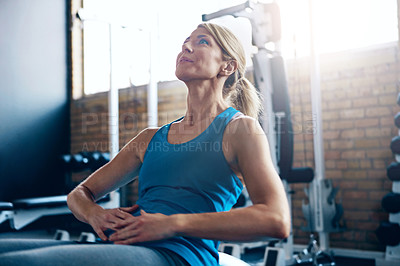 Buy stock photo Shot of a sporty woman doing sit-ups at the gym