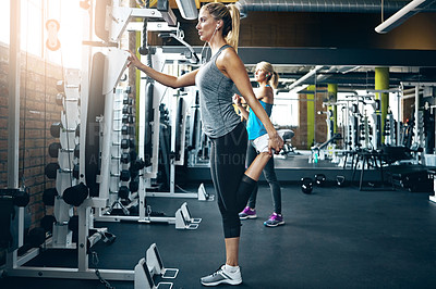 Buy stock photo Shot of a sporty woman working out at the gym