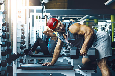 Buy stock photo Shot of a man doing weight training at the gym