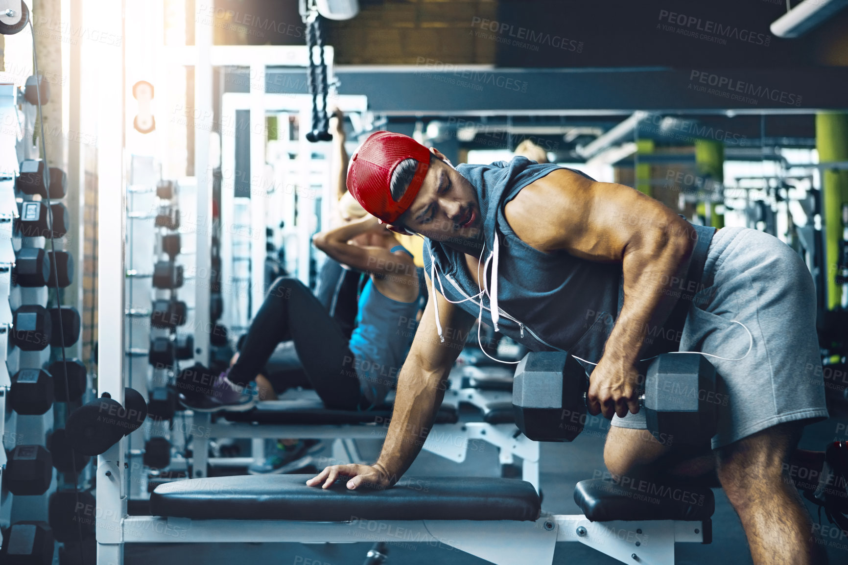 Buy stock photo Shot of a man doing weight training at the gym