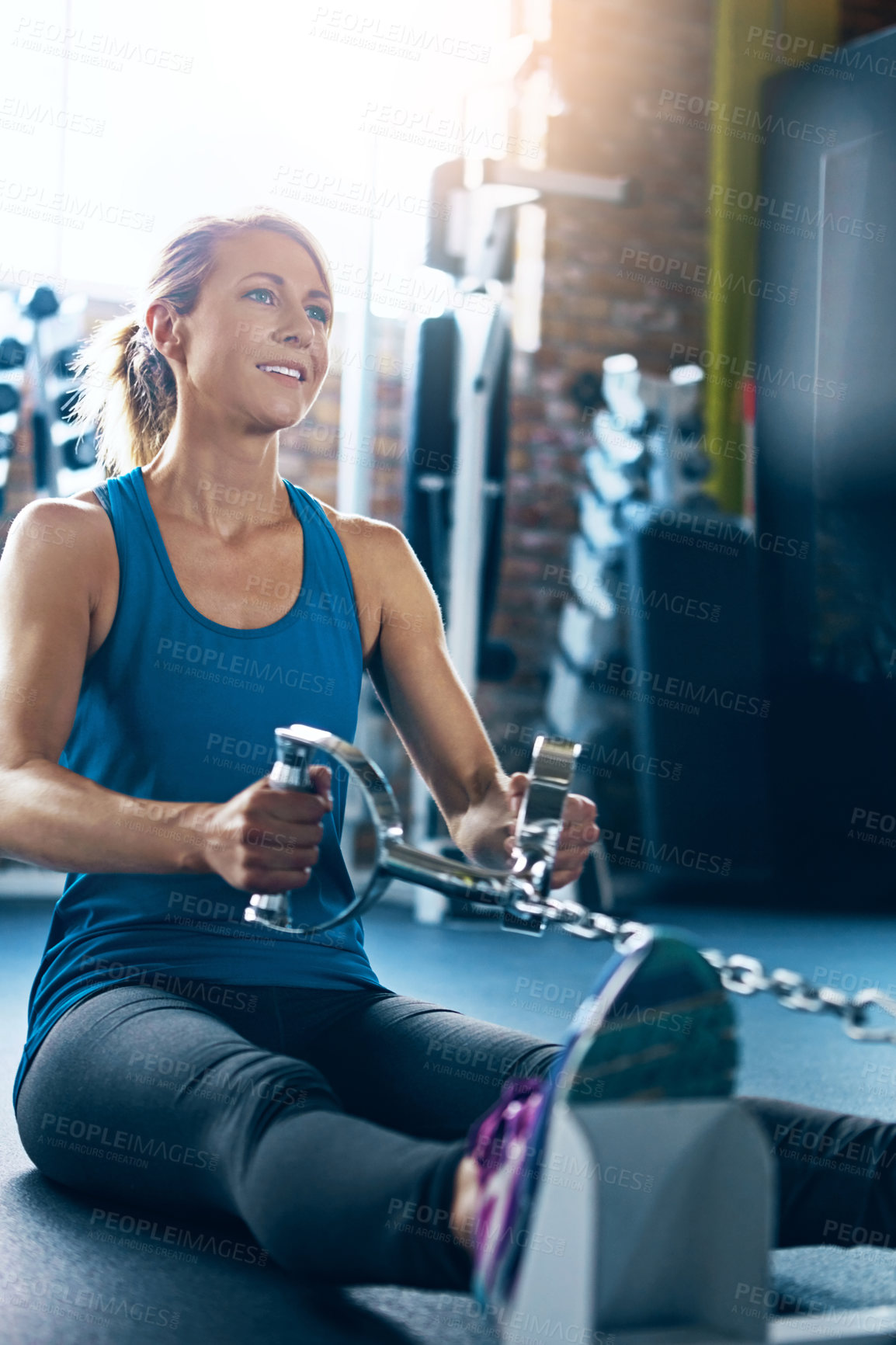 Buy stock photo Shot of a sporty woman working out at the gym