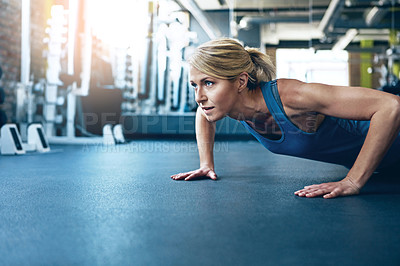 Buy stock photo Shot of a sporty woman working out at the gym