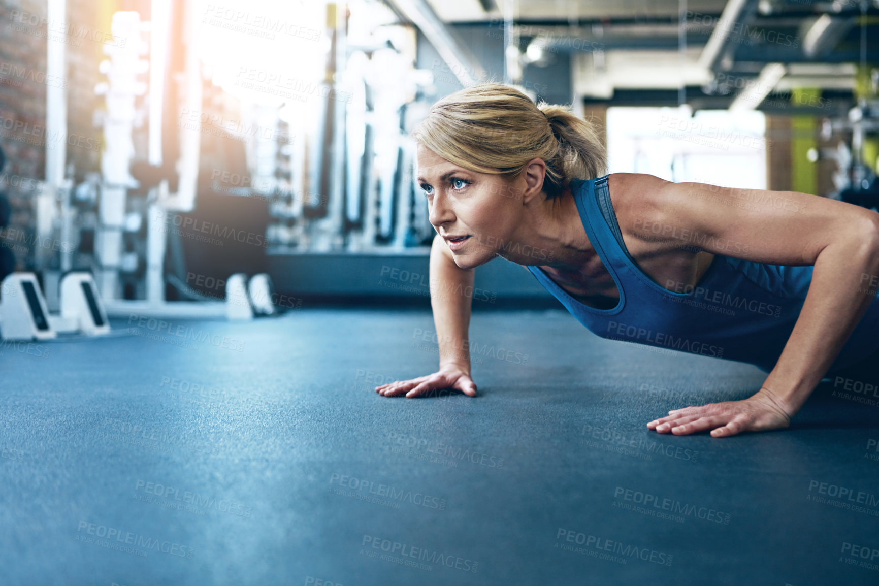 Buy stock photo Shot of a sporty woman working out at the gym