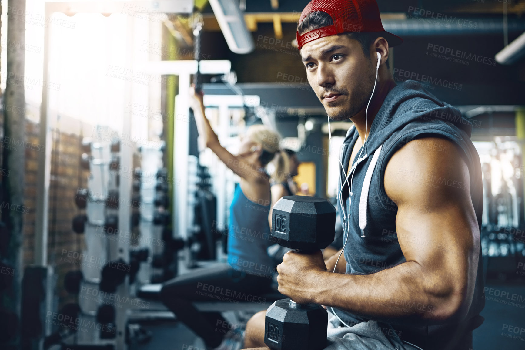 Buy stock photo Shot of a man doing weight training at the gym