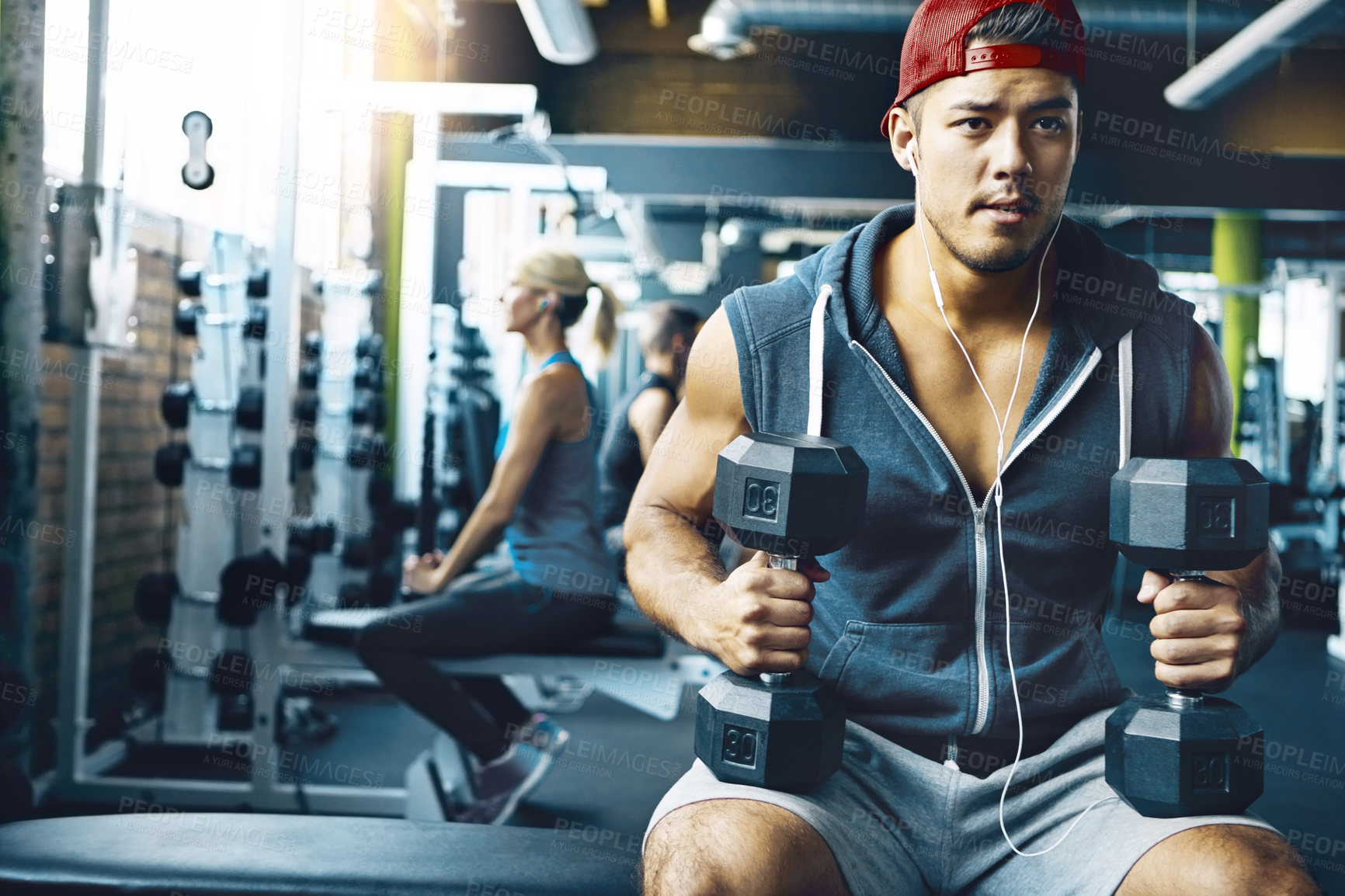 Buy stock photo Shot of a man doing a upper-body workout at the gym