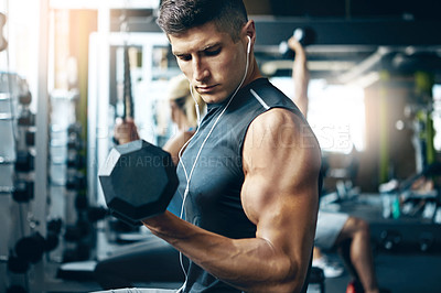 Buy stock photo Shot of a man doing weight training at the gym