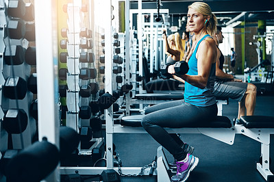 Buy stock photo Shot of a sporty woman working out at the gym