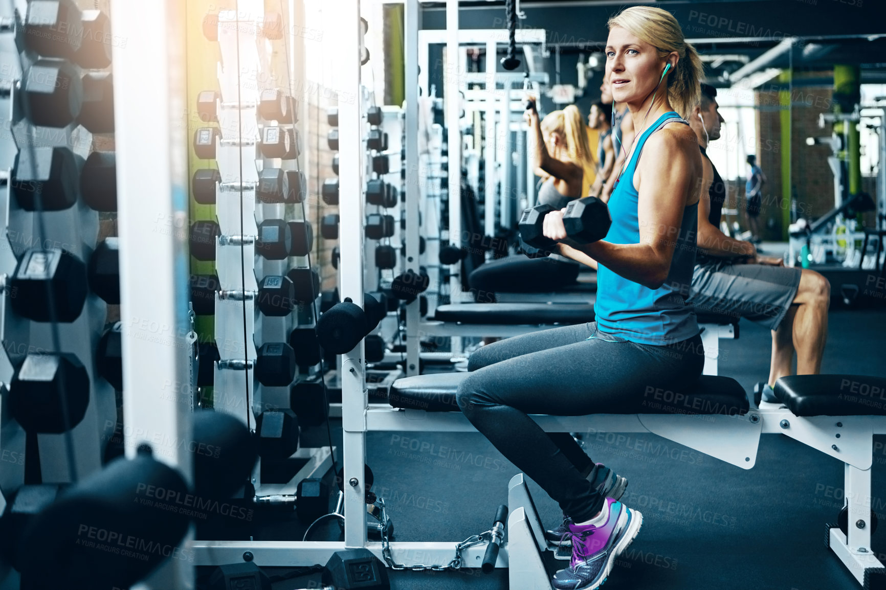 Buy stock photo Shot of a sporty woman working out at the gym