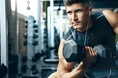 Buy stock photo Shot of a man doing a upper-body workout at the gym