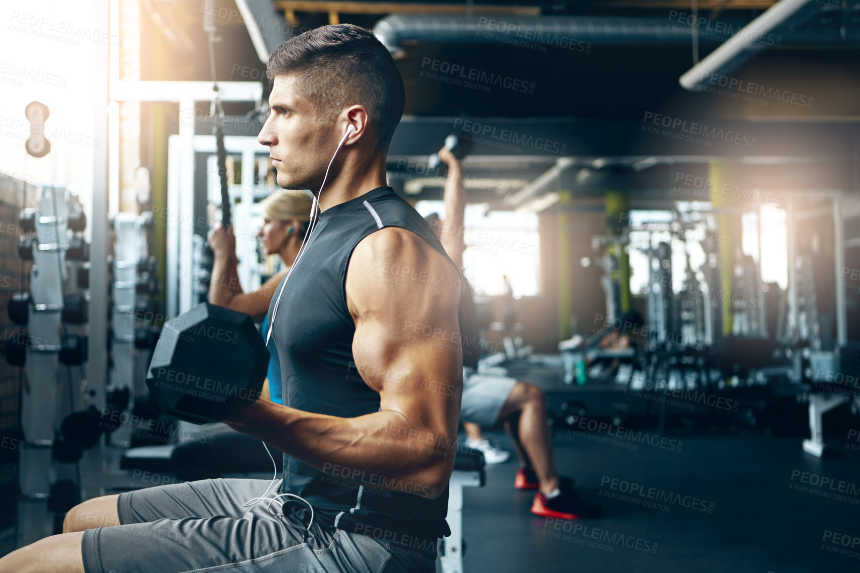 Buy stock photo Shot of a man doing a upper-body workout at the gym