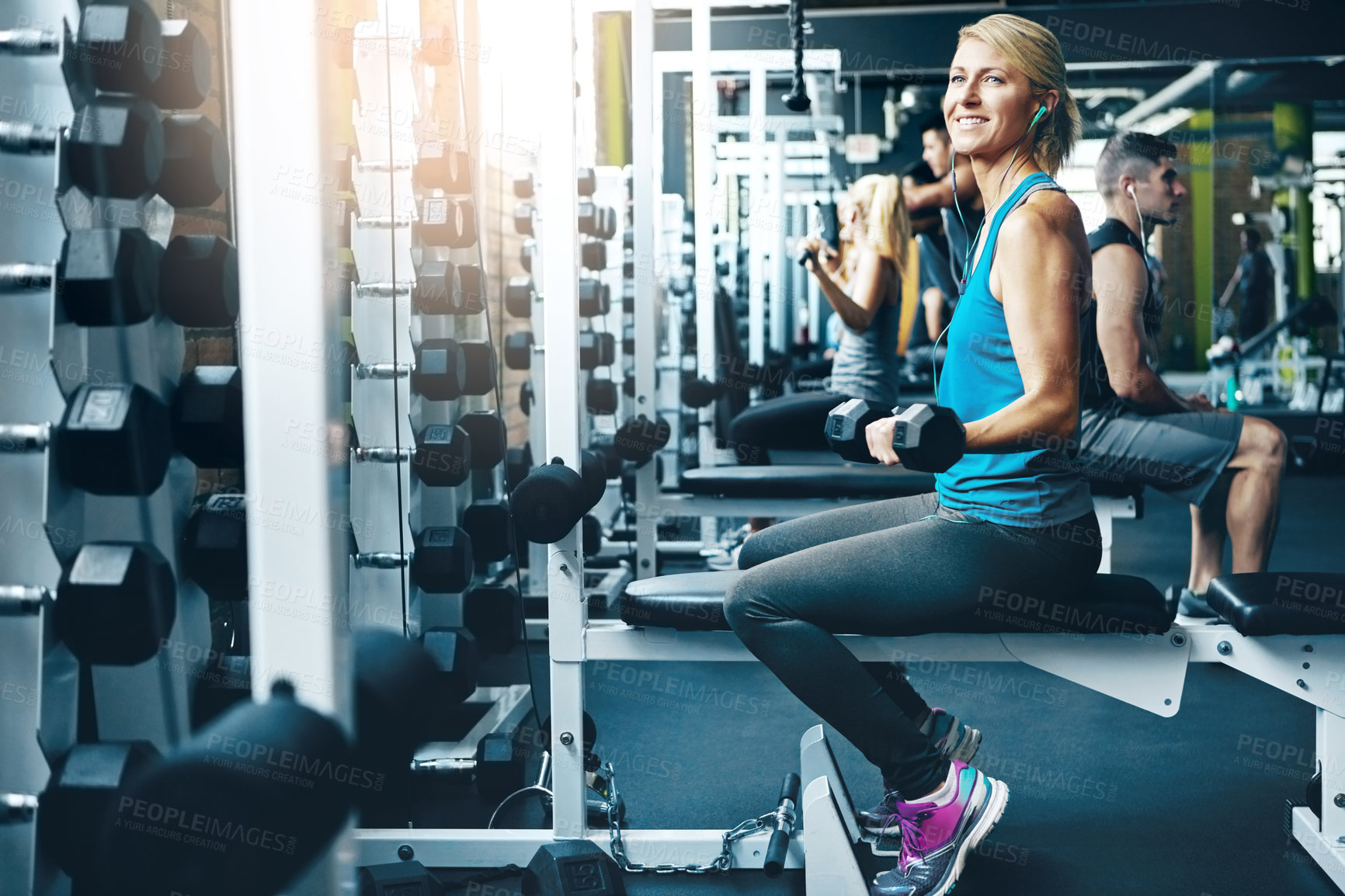 Buy stock photo Shot of a woman doing a upper-body workout at the gym