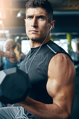 Buy stock photo Shot of a man doing weight training at the gym