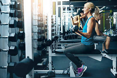 Buy stock photo Shot of a woman doing a upper-body workout at the gym