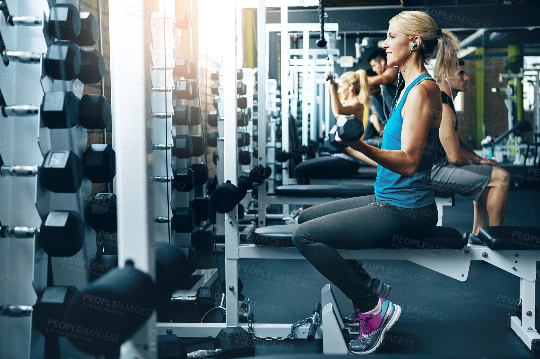 Buy stock photo Shot of a woman doing a upper-body workout at the gym