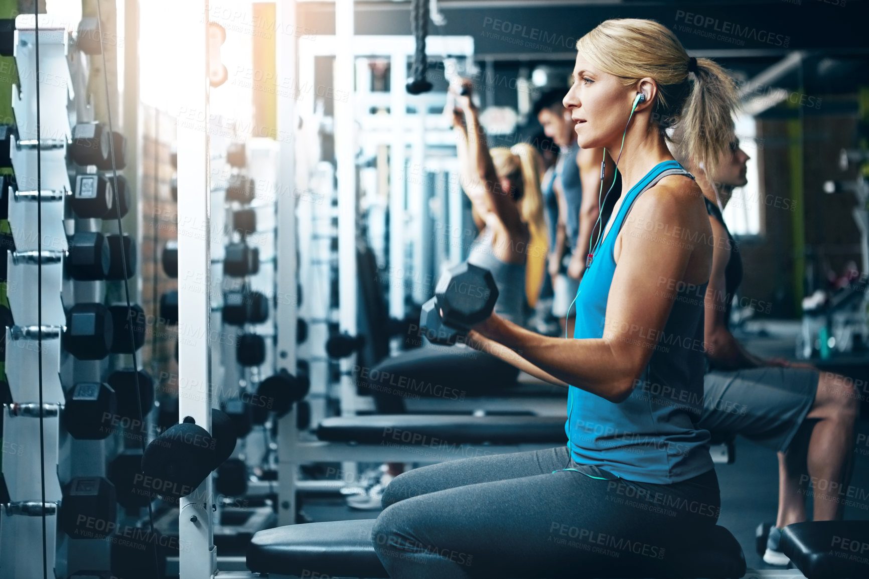 Buy stock photo Shot of a woman doing a upper-body workout at the gym