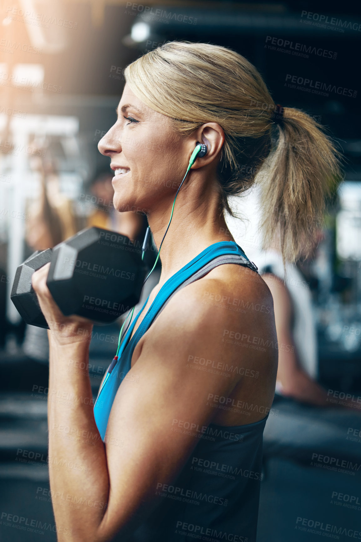 Buy stock photo Fitness, dumbbell and earphones with woman in gym for streaming tutorial, bodybuilder and audio. Workout playlist, muscle development and strength training guide with person for weightlifting
