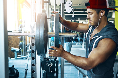 Buy stock photo Shot of a man doing weight training at the gym