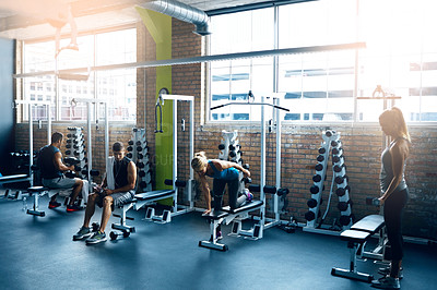 Buy stock photo Shot of a group of people working out in the gym