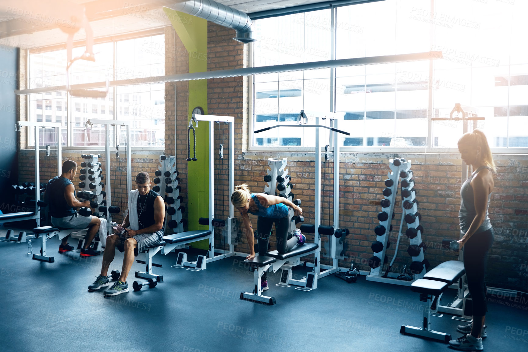 Buy stock photo Shot of a group of people working out in the gym