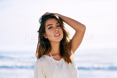 Buy stock photo Cropped shot of a beautiful young woman posing on the beach