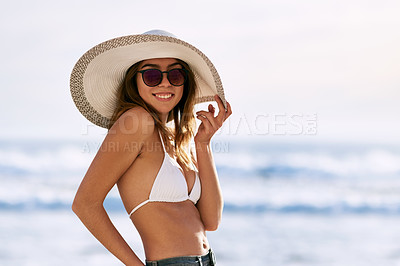 Buy stock photo Cropped shot of a beautiful young woman posing in her bikini top on the beach