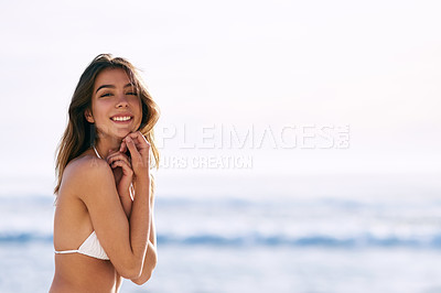 Buy stock photo Cropped shot of a beautiful young woman posing in her bikini top on the beach