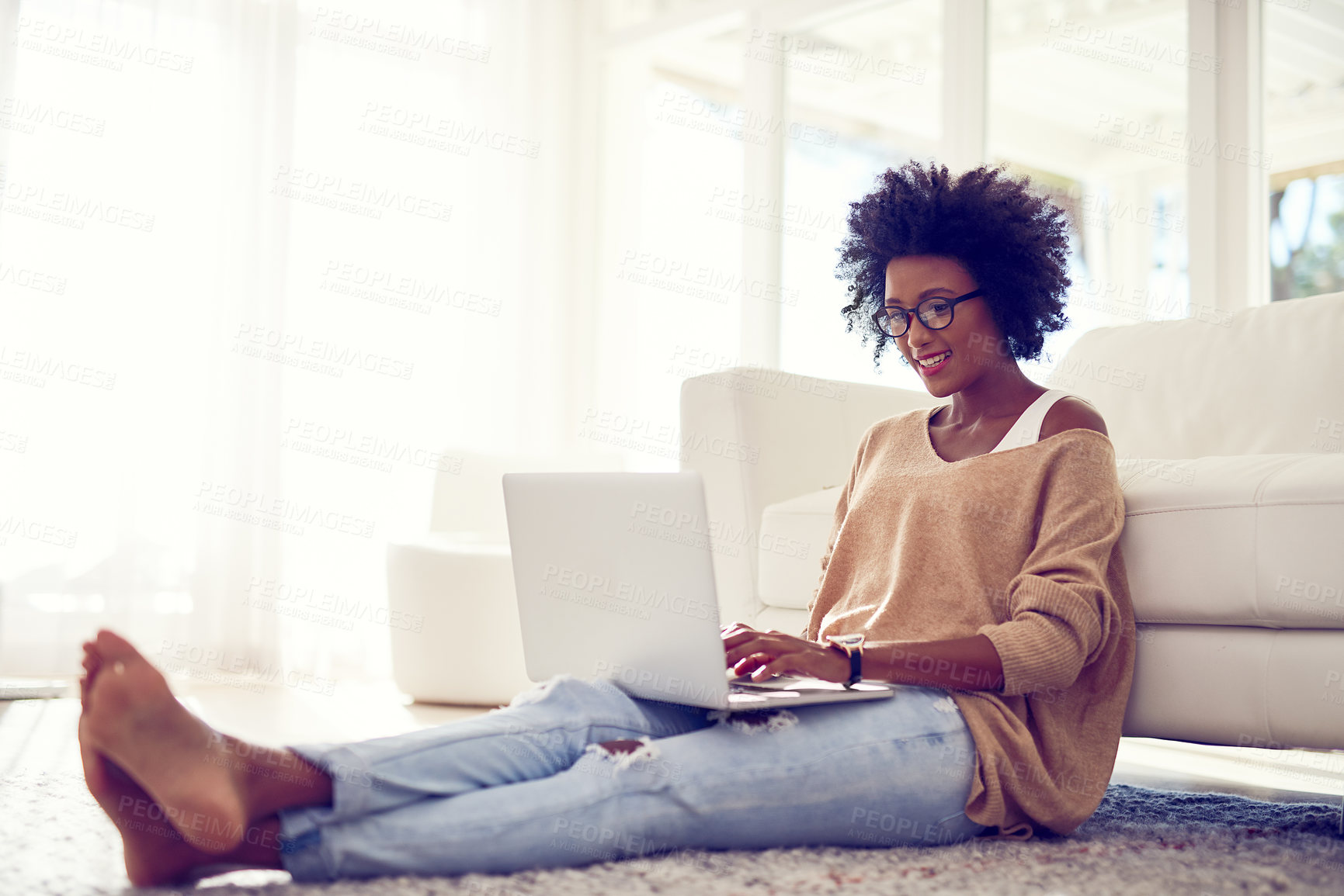 Buy stock photo Shot of a young woman using a laptop at home