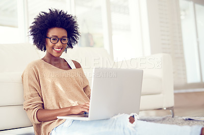 Buy stock photo Shot of a young woman using a laptop at home