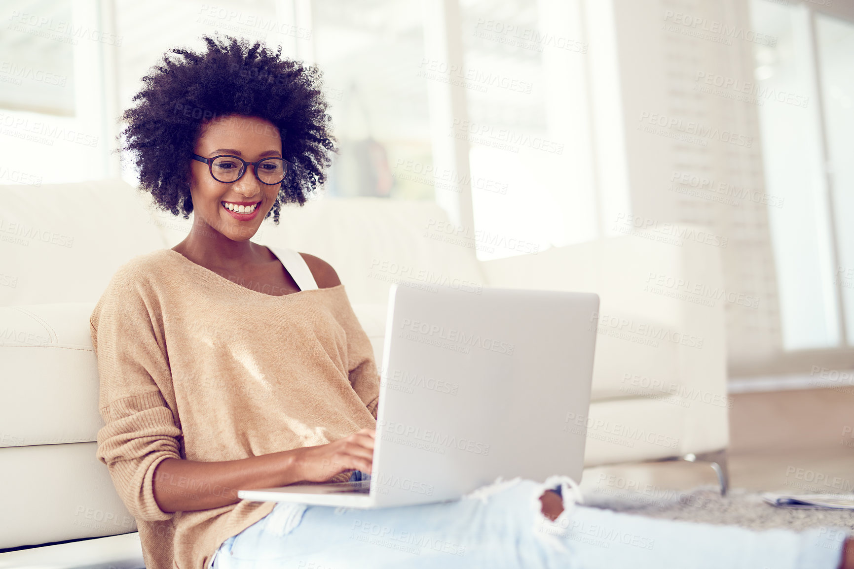 Buy stock photo Shot of a young woman using a laptop at home