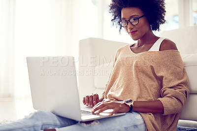 Buy stock photo Shot of a young woman using a laptop at home