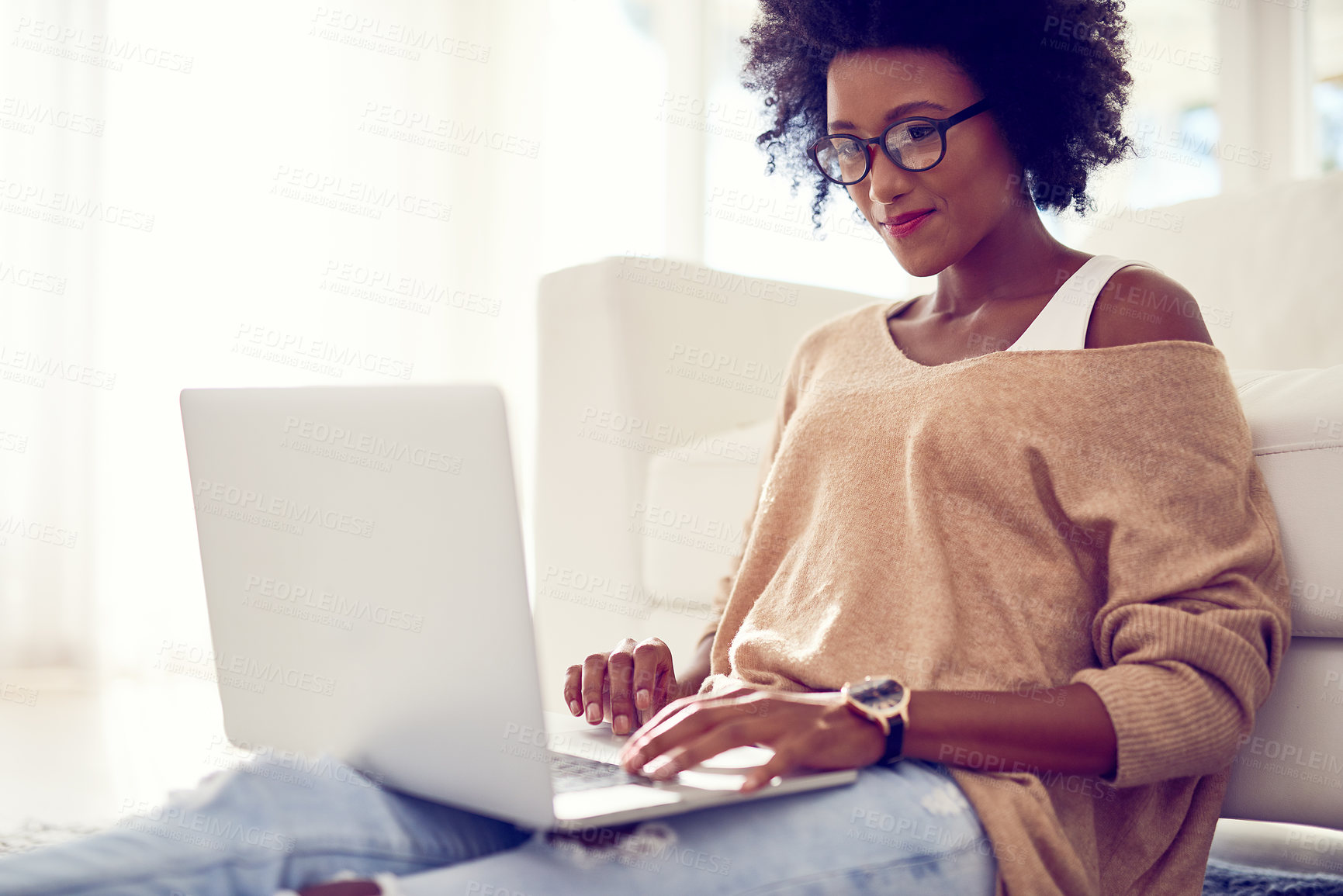 Buy stock photo Shot of a young woman using a laptop at home