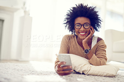 Buy stock photo Woman, smartphone and home portrait for relax, networking and social media news or browsing on web for communication on floor. Living room, happy and smile for internet search, comfort and house
