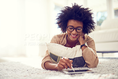 Buy stock photo Happy, black woman and writing with tablet for design or digital artist on living room floor at home. African female person, freelancer or young designer with smile on technology for creative startup