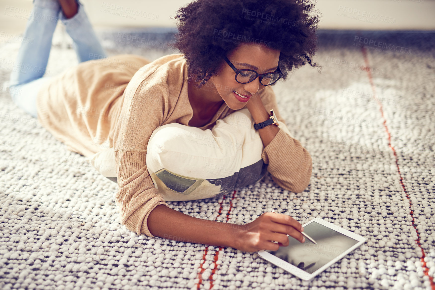 Buy stock photo Shot of a young woman using a digital tablet at home