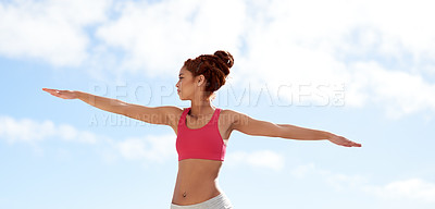 Buy stock photo Shot of a young woman practicing yoga outside on a sunny day