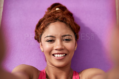 Buy stock photo Portrait of a young woman practicing lying on a yoga mat outside